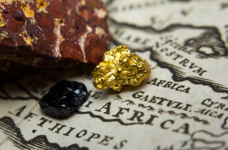 Minerals such as gold on a map of Africa representing the valuable African import and export commodites you can find on Tragoa