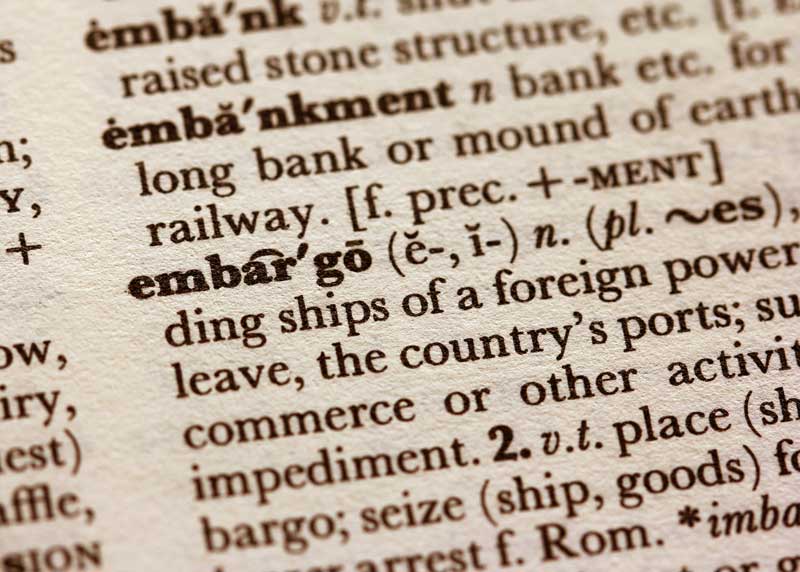 An image of a dictionary with the definition of embargo which represents this blog post educating on terms related to e-logistics, logistics, trade finance, trade lending and more. All of which are services offered on the best African B2B marketplace, TRAGOA.
